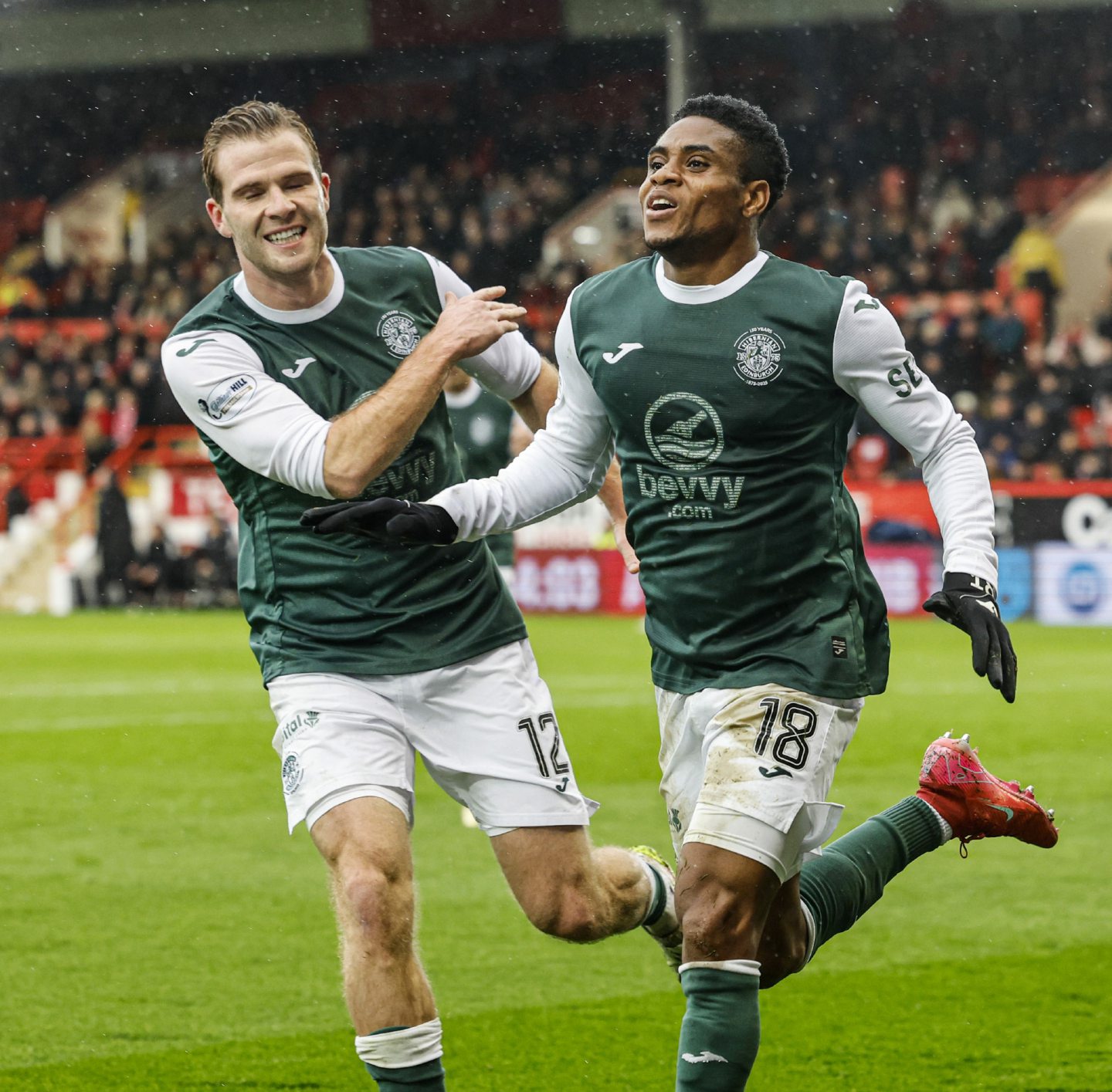Hibernian's Thibault Klidje celebrates with Chris Cadden (L) as he scores to make it 1-0 against Aberdeen.