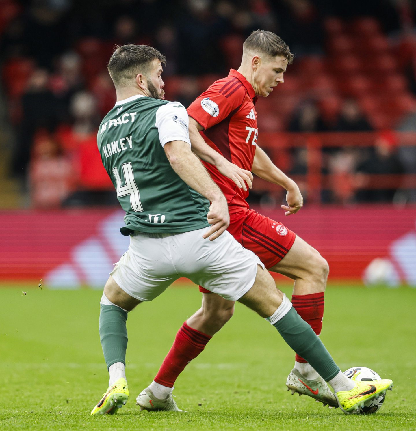 Hibernian's Grant Hanley and Aberdeen's Kevin Nisbet in action at Pittodrie.