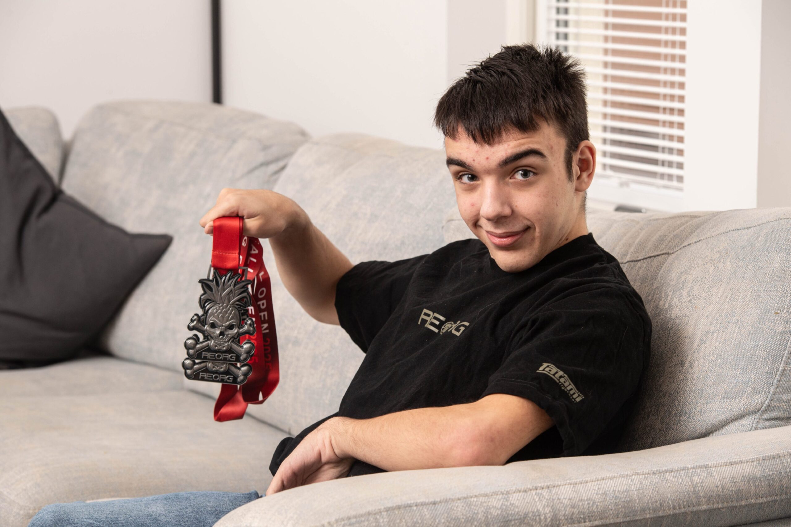 Liam Wilson relaxing at home with his medal haul