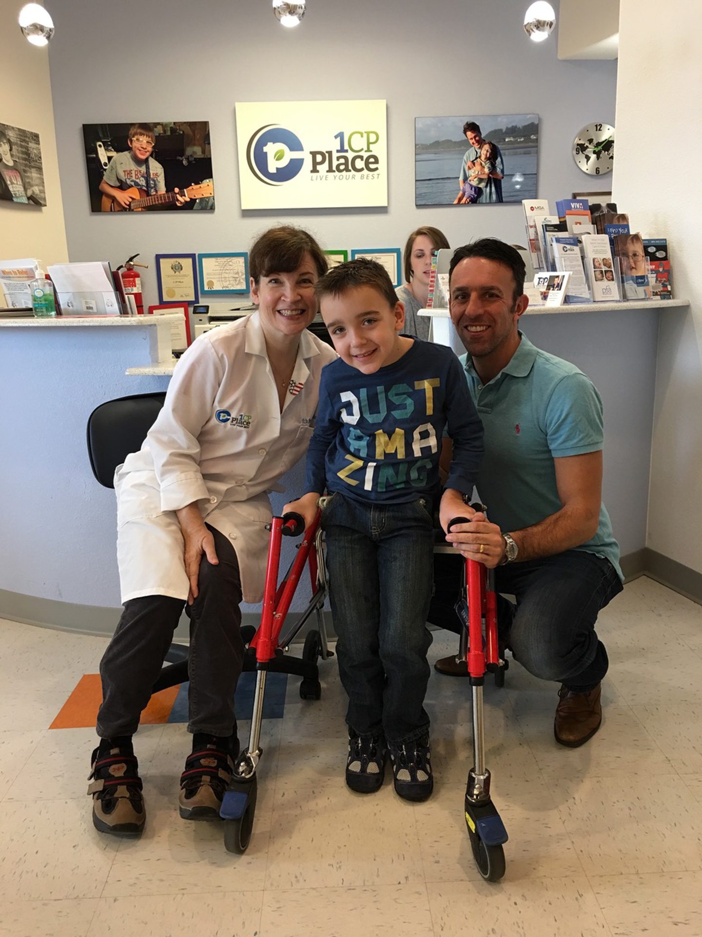 Liam flanked by a doctor and his dad at a clinic