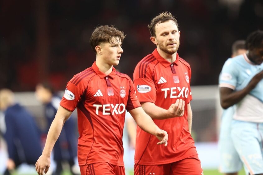Dylan Lobban and Nicky Devlin of Aberdeen chat during league match against Motherwell at Pittodrie