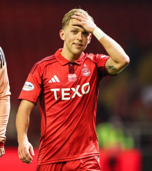 Jesper Karlsson holds his hand to his head but grins at the final whistle