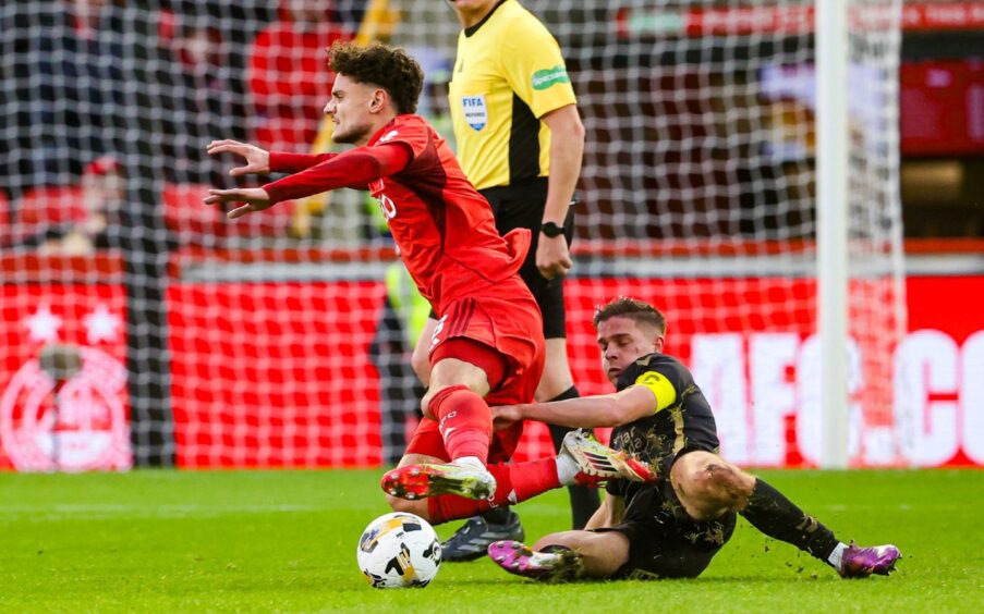 Aberdeen's Dante Polvara (L) and Hearts' Cammy Devlin in action at Pittodrie.
