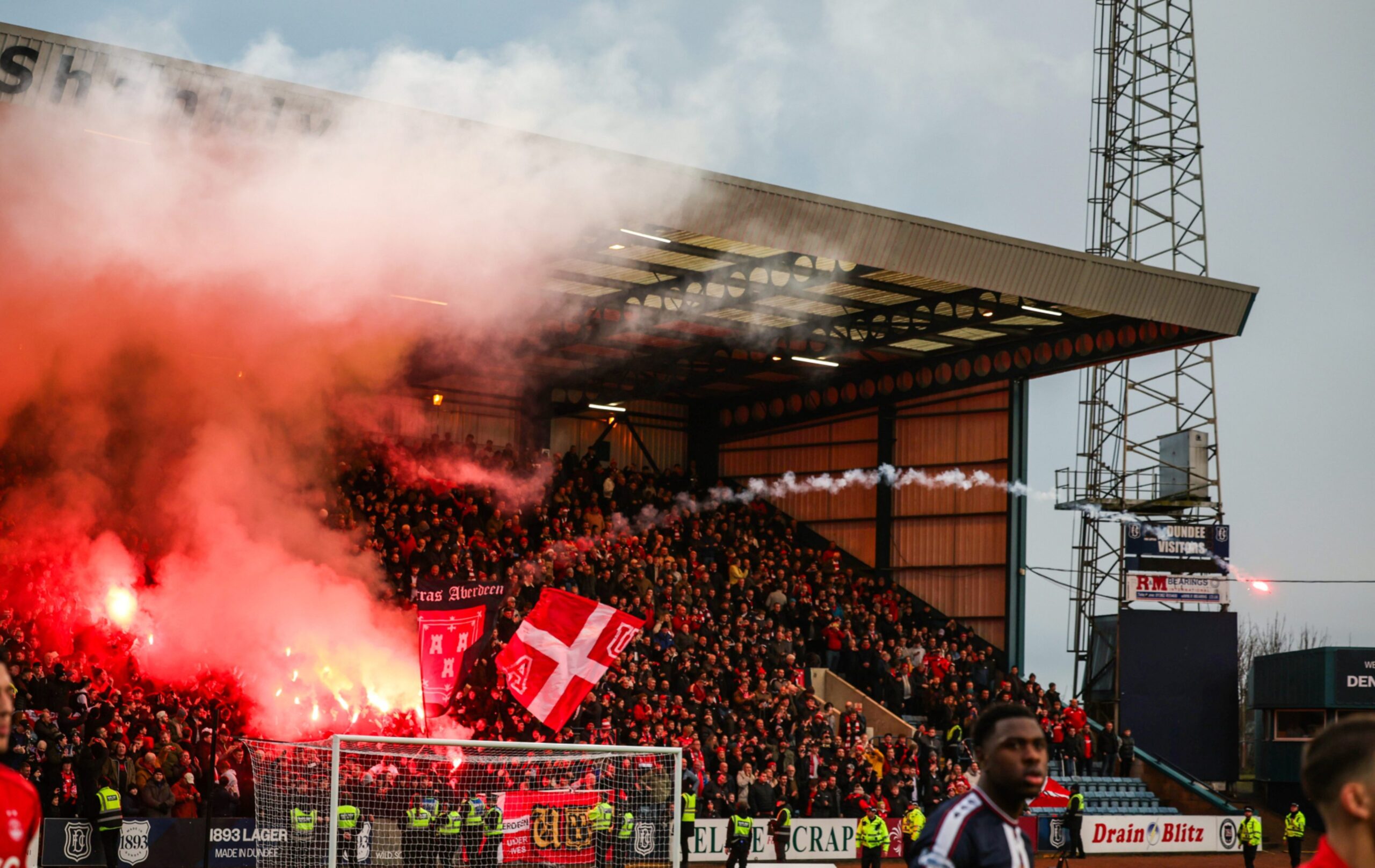 Aberdeen fan throws a flare on the pitch before a William Hill Premiership match against Dundee.