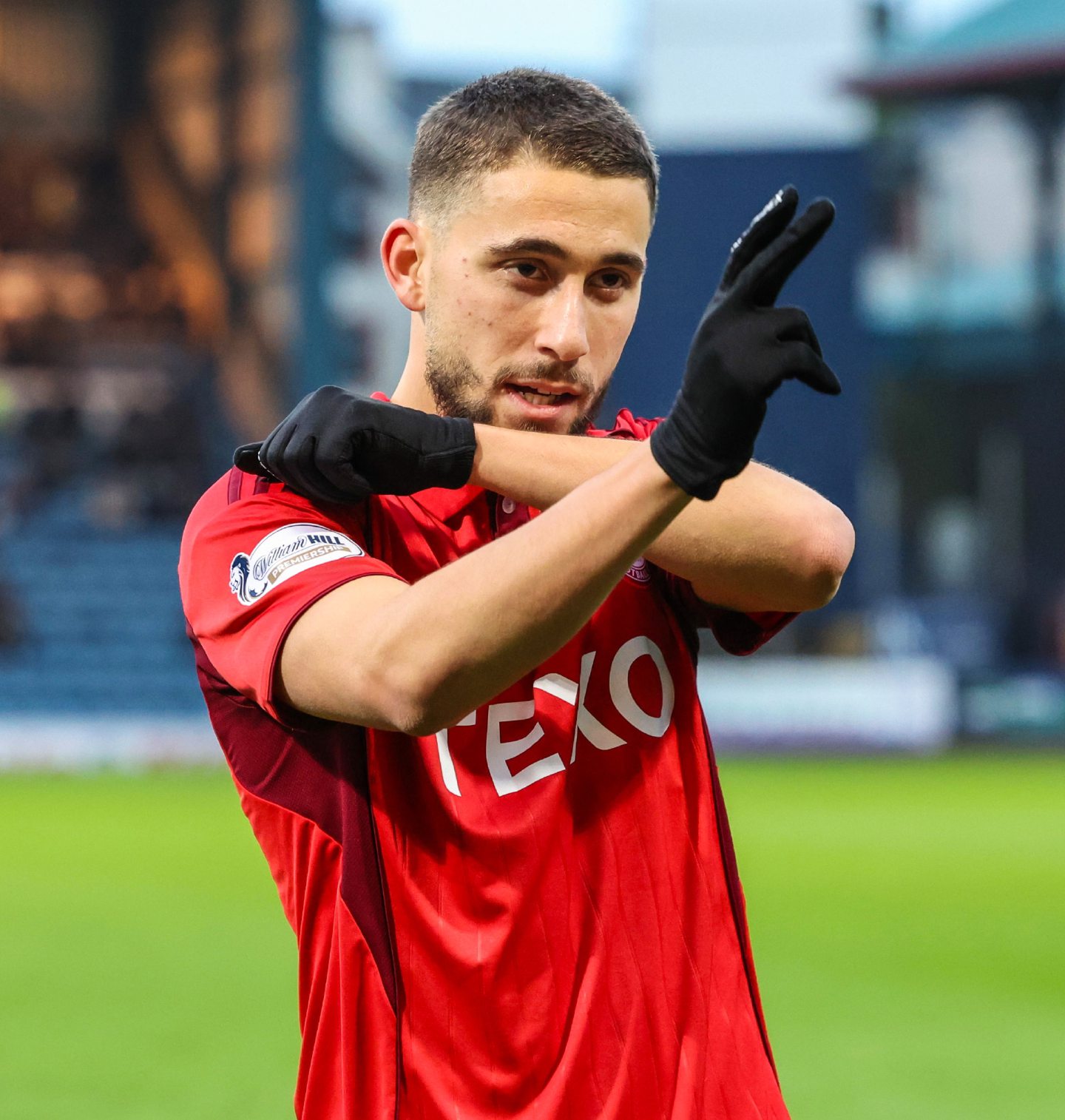 Aberdeen's Adil Aouchiche celebrates after scoring against Dundee at Dens Park.