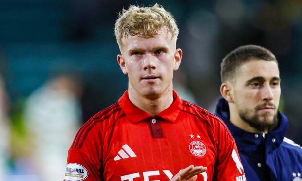 Aberdeen's Kjartan Mar Kjartansson applauds fans at full-time against Celtic. Image: SNS.