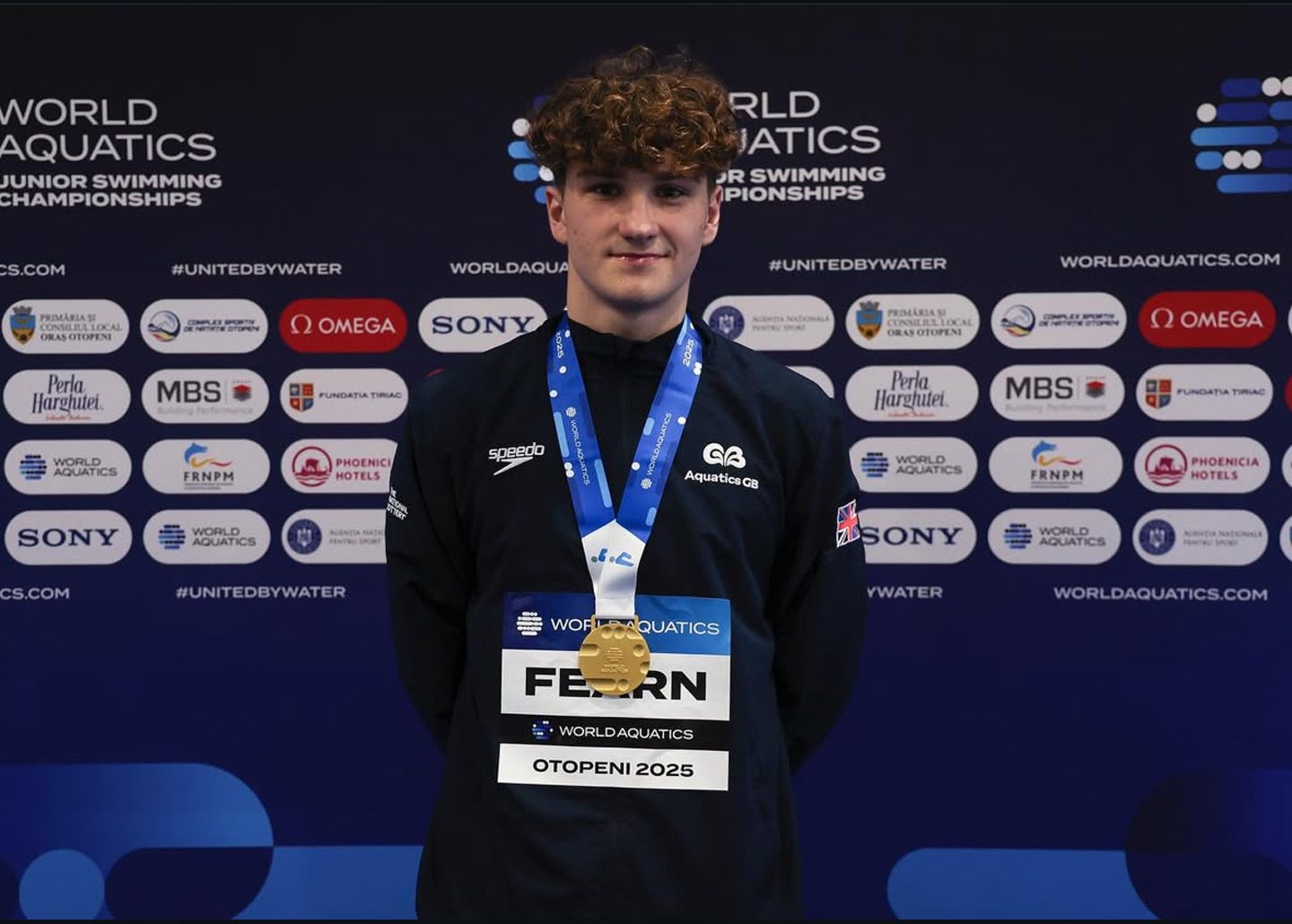 Dean Fearn in sports gear with a medal round his neck