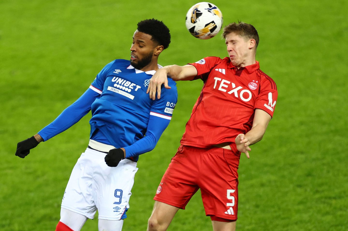 Youssef Chermiti of Rangers jumps with Mats Knoester of Aberdeen during the 2-0 loss at Ibrox.