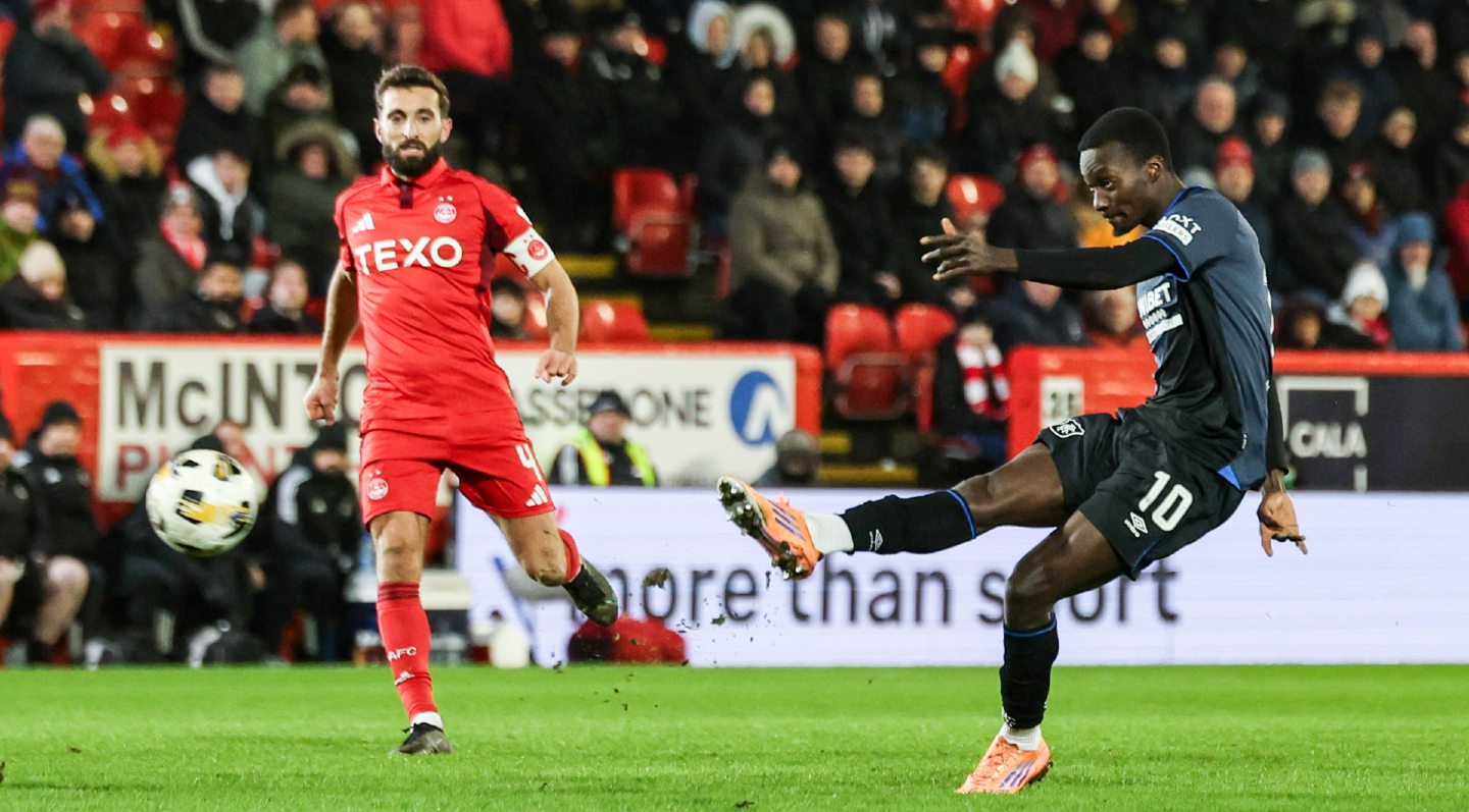 Rangers' Mohamed Diomande (R) has a strike at goal against Aberdeen at Pittodrie.