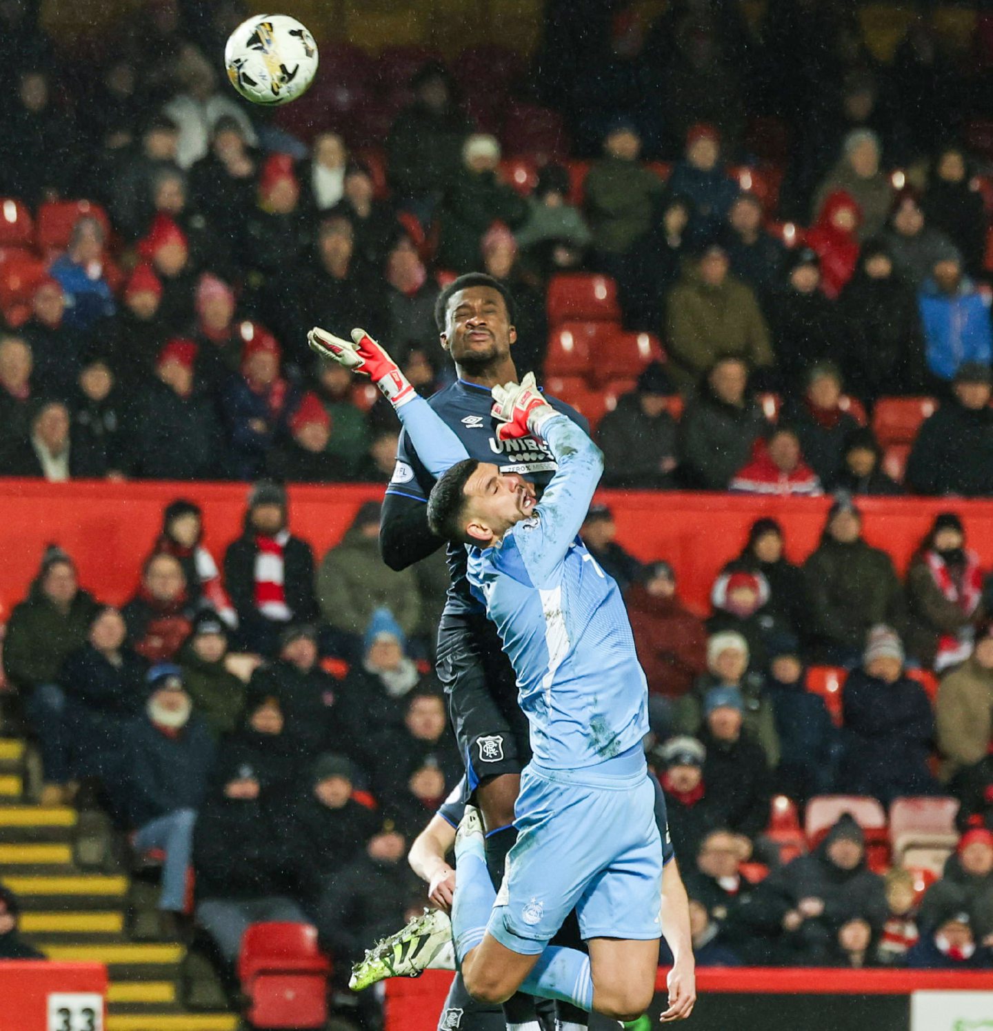 Rangers' Emmanuel Fernandez (L) beats Aberdeen goalkeeper Dimitar Mitov to the ball in the air but the goal is disallowed for a foul following a VAR check