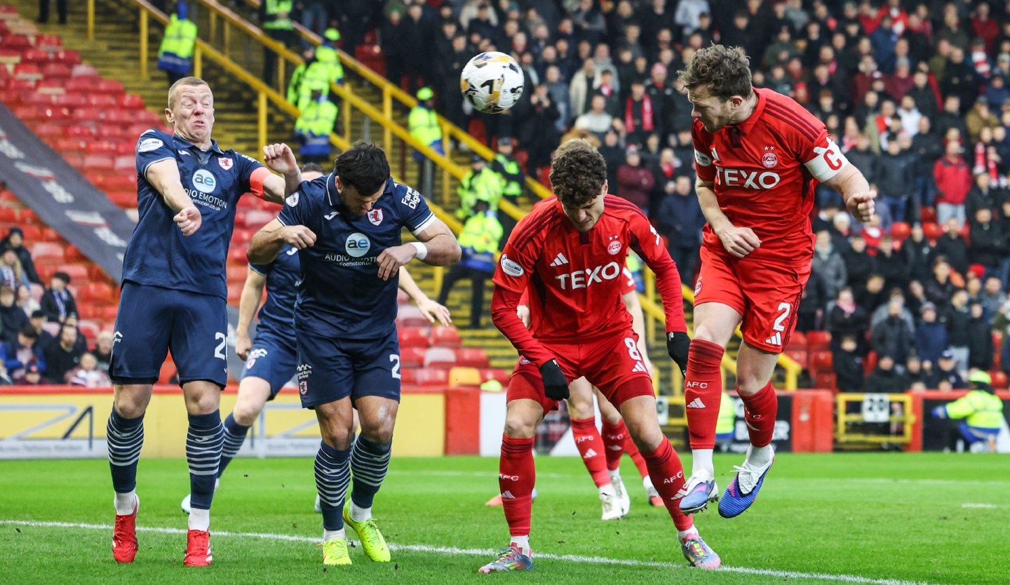  Aberdeen's Nicky Devlin (R) has a header at goal against Raith Rovers.