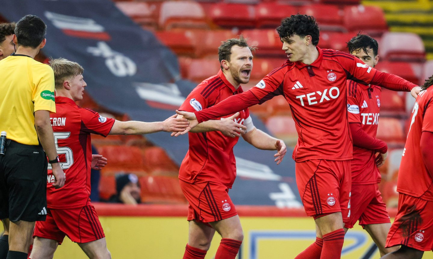 Aberdeen's Jack Milne (R) celebrates scoring to make it 1-0 with Lyall Cameron during a Scottish Cup clash against Raith Roves. 