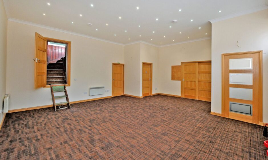 Salem Gospel Hall worship hall. It is bright and spacious, with cream walls and light wood doors.