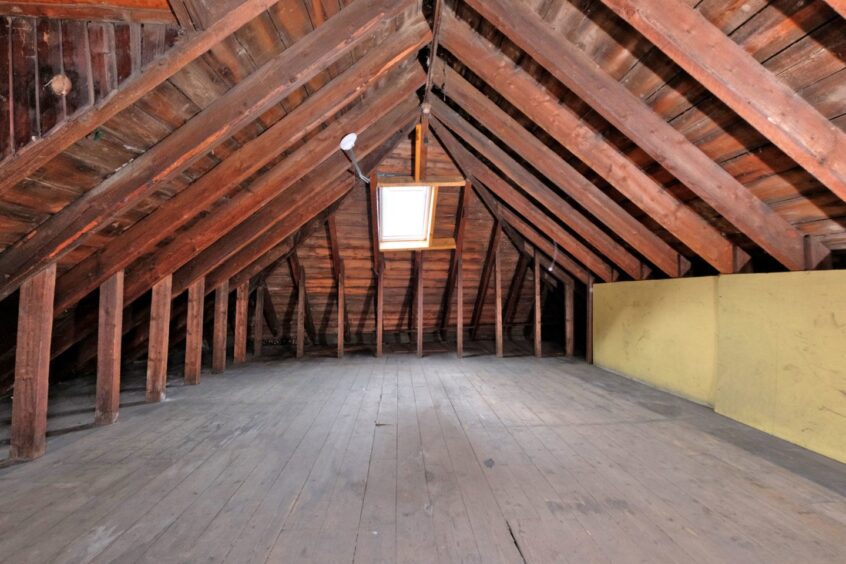 Salem Gospel Hall's large attic, with wooden roof beams.