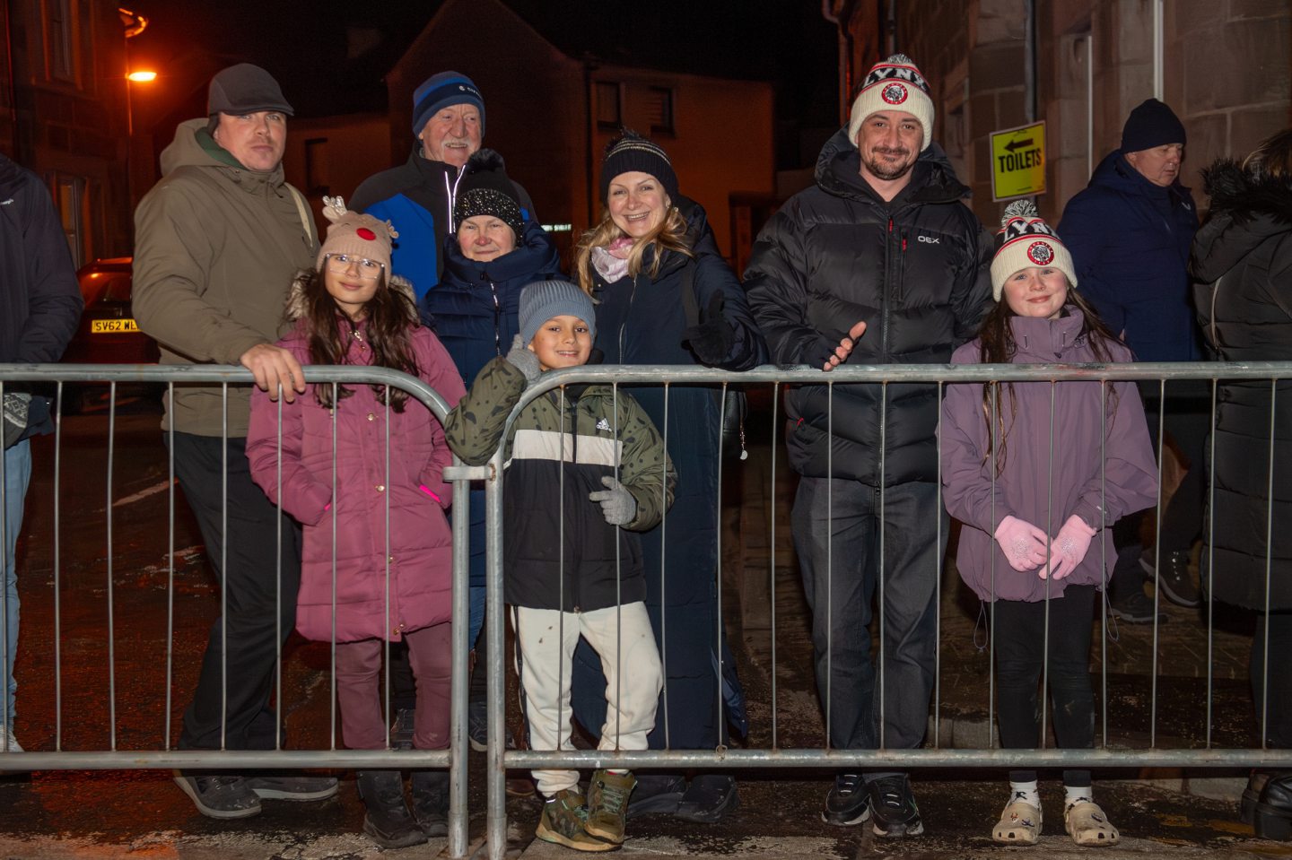 Families with children wait behind barriers to watch the Stonehaven Fireballs Hogmanay procession on Stonehaven High Street, January 1 2026.
