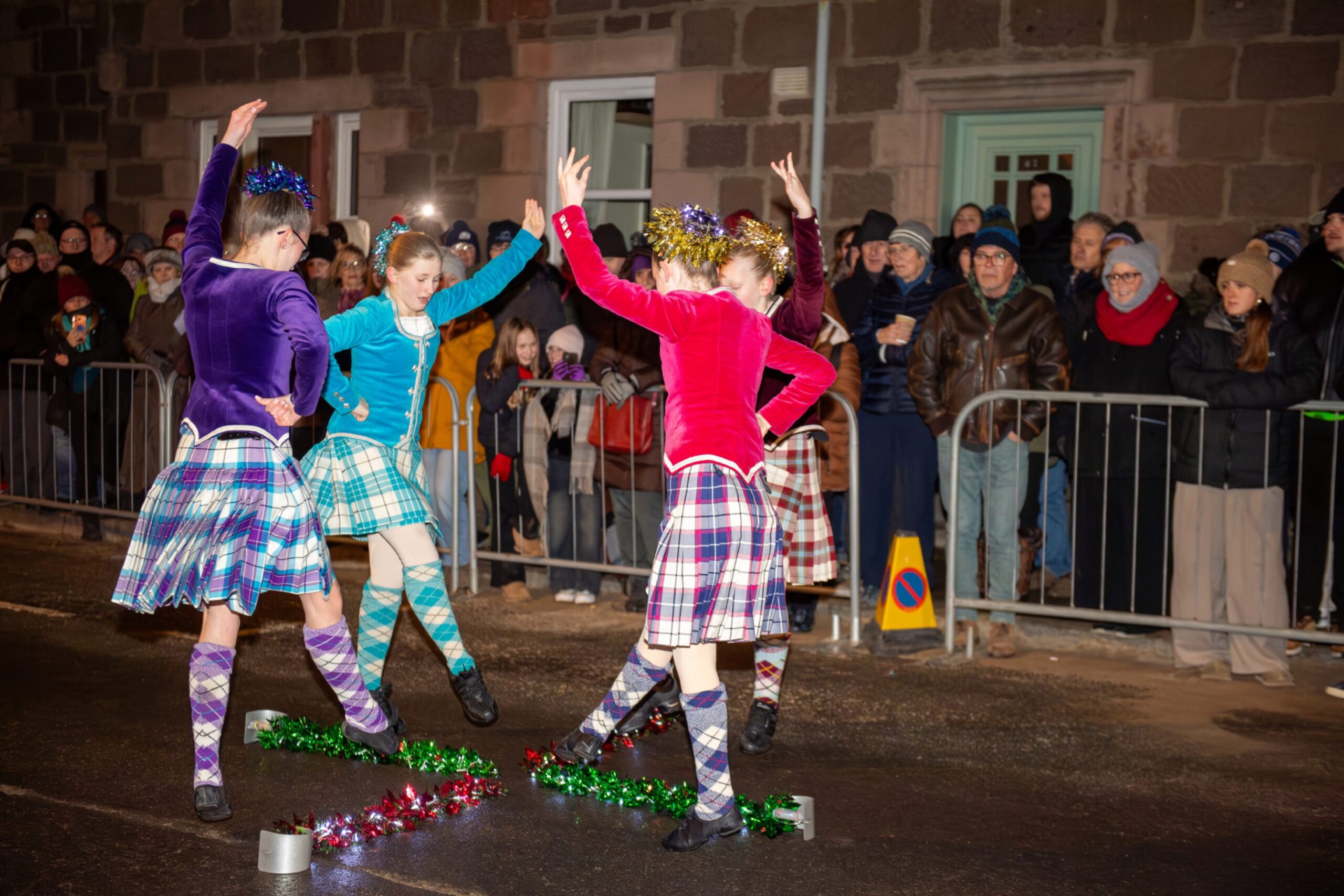 Young Highland dancers perform in tartan costumes in front of spectators during the Stonehaven Fireballs celebrations on Stonehaven High Street, January 1 2026.