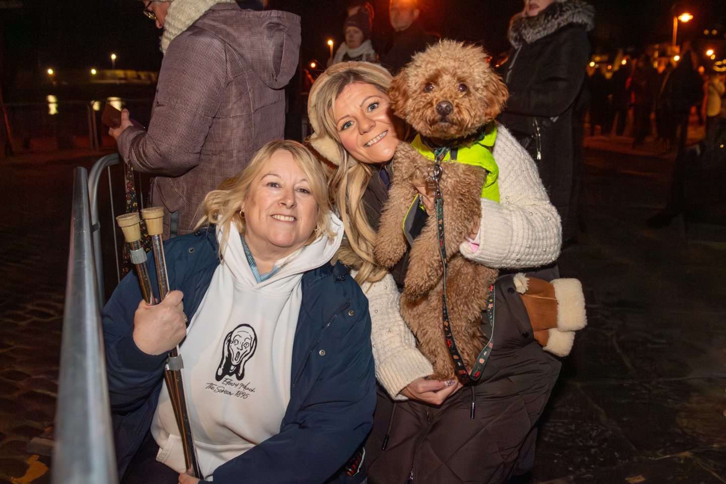 Helen Blackburn and Kirsty Procter pose with their dog Keef during the Stonehaven Fireballs celebrations near Stonehaven Harbour on January 1 2026.