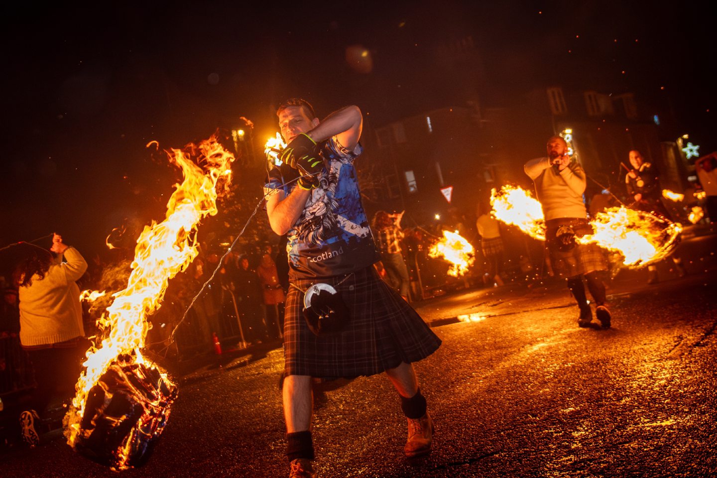 Fireball swingers march along Stonehaven High Street, spinning flaming fireballs during the Stonehaven Fireballs Hogmanay celebrations, January 1 2026.