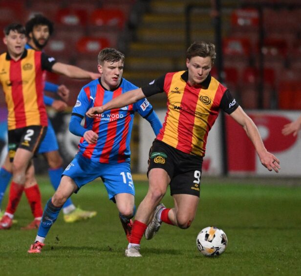 Inverness Caledonian Thistle midfielder Alfie Stewart, left, closes in on Partick Thistle forward Alex Samuel during a KDM Evolution Trophy third round tie at Firhill Stadium, Glasgow, on January 13, 2026. It ended 3-3, with Inverness winning 4-2 on penalties to reach the quarter-finals. 