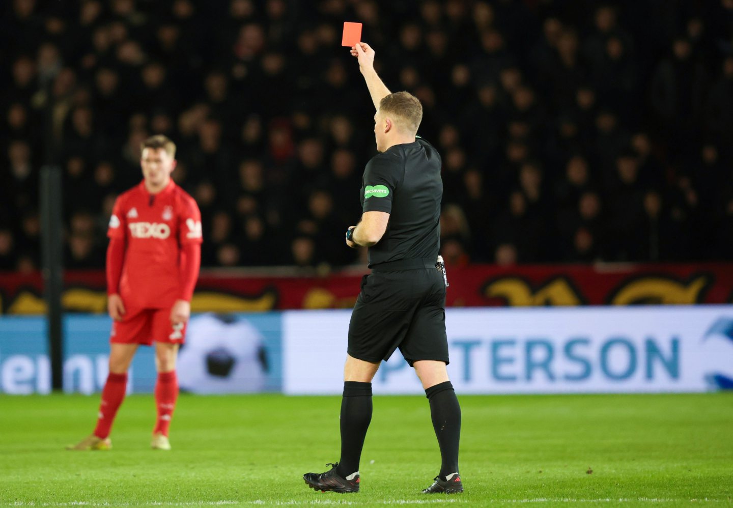 Referee John Beaton upgrades Dennis Geiger's yellow card to a red following a VAR check during the 2-0 Scottish Cup win against Motherwell. 