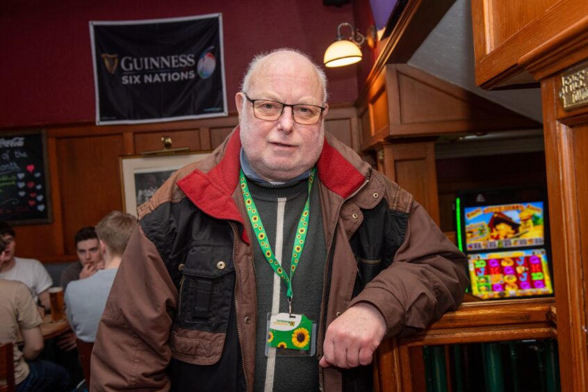 Sandy standing at pub.