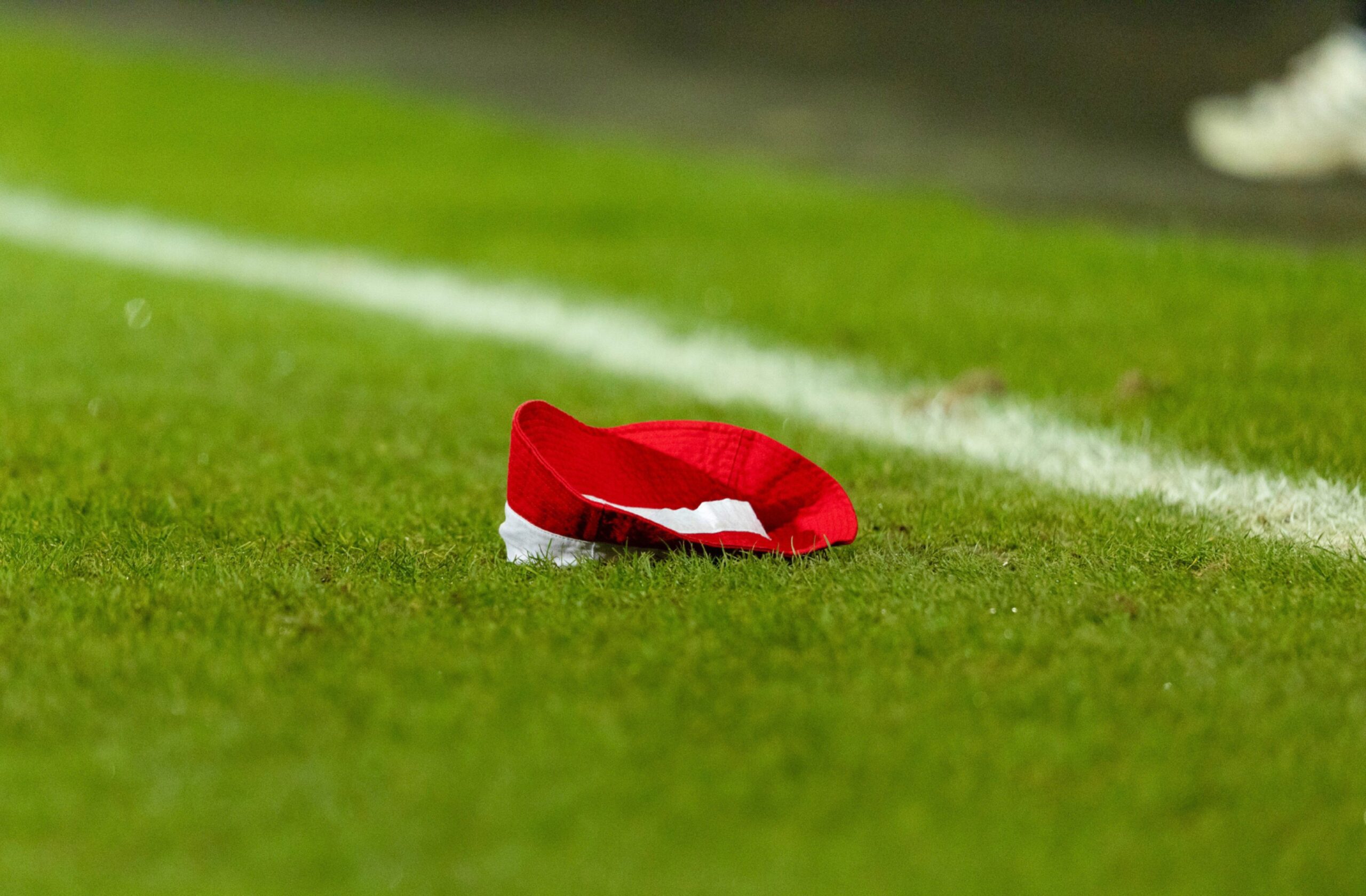 An Aberdeen hat is thrown onto the pitch during the 3-0 loss to Dunfermline Athletic.