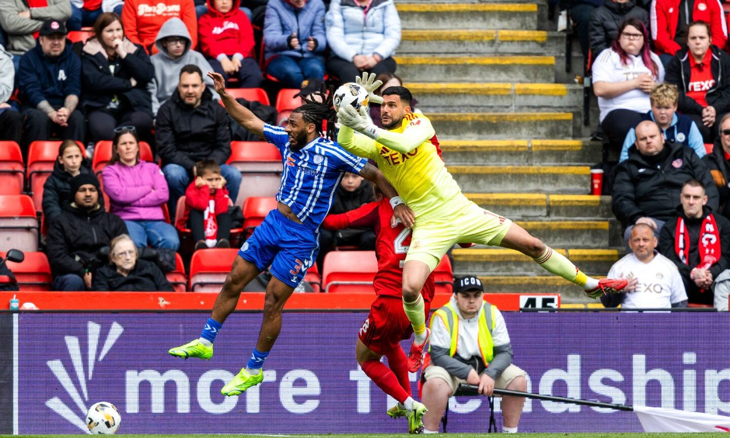 Aberdeen's Dimitar Mitov and Kilmarnock's Dominic Thompson in action in 1-0 win at Pittodrie. Image: SNS