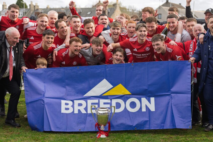 Brora Rangers players celebrate with the trophy after winning the Breedon Highland League title at Huntly on April 11, 2026. 