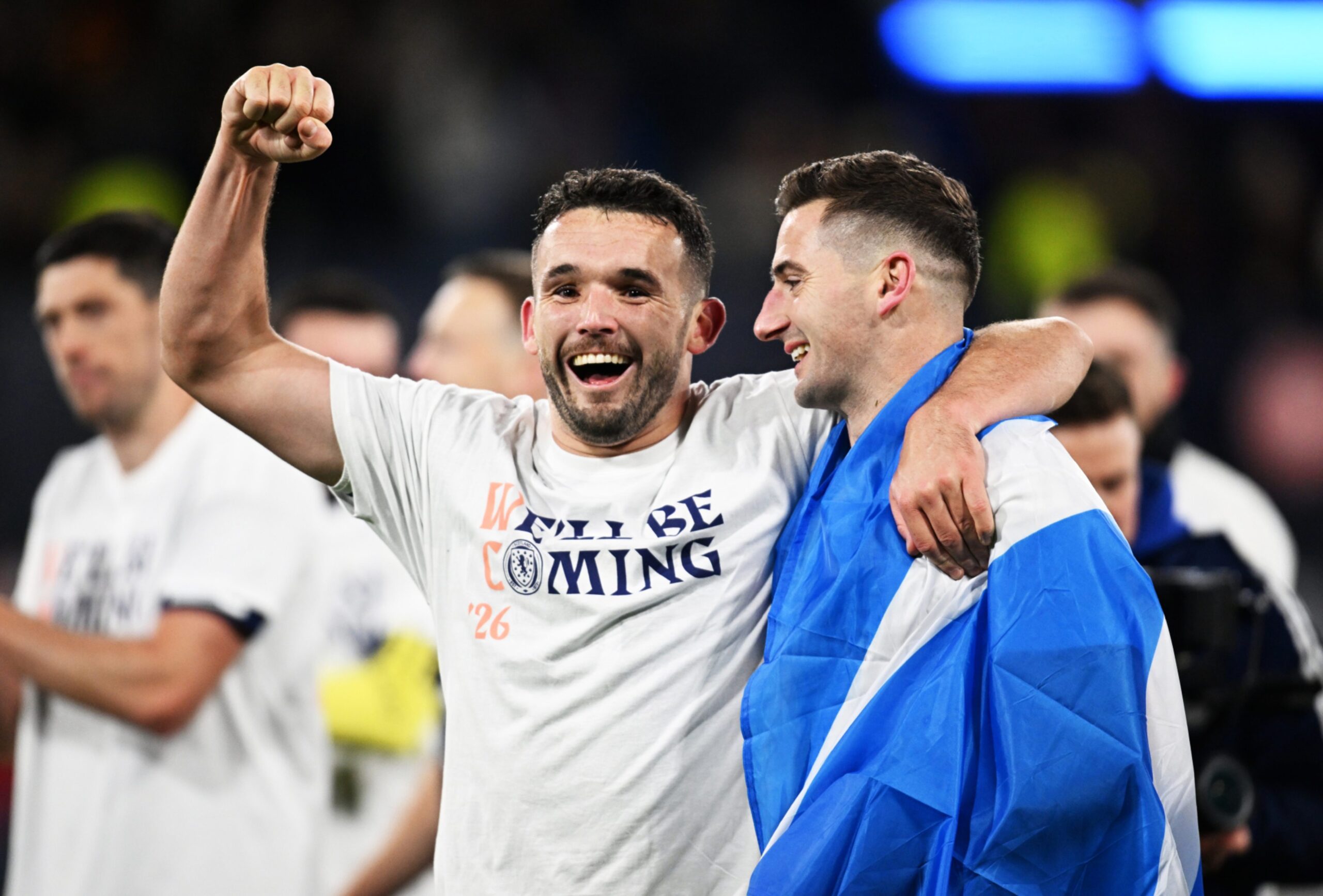Scotland's John McGinn and Kenny McLean celebrate after qualifying for the 2026 FIFA World with a 4-2 win against Denmark.