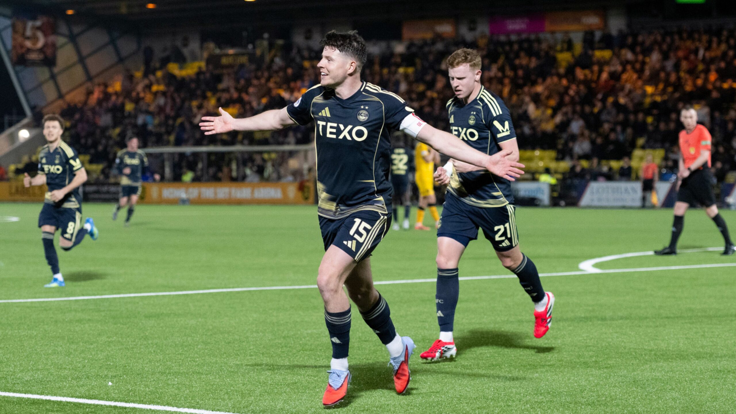 Aberdeen's Kevin Nisbet celebrates after his header comes off of Livingston's Daniel Finlayson and into the net to make it 2-1.