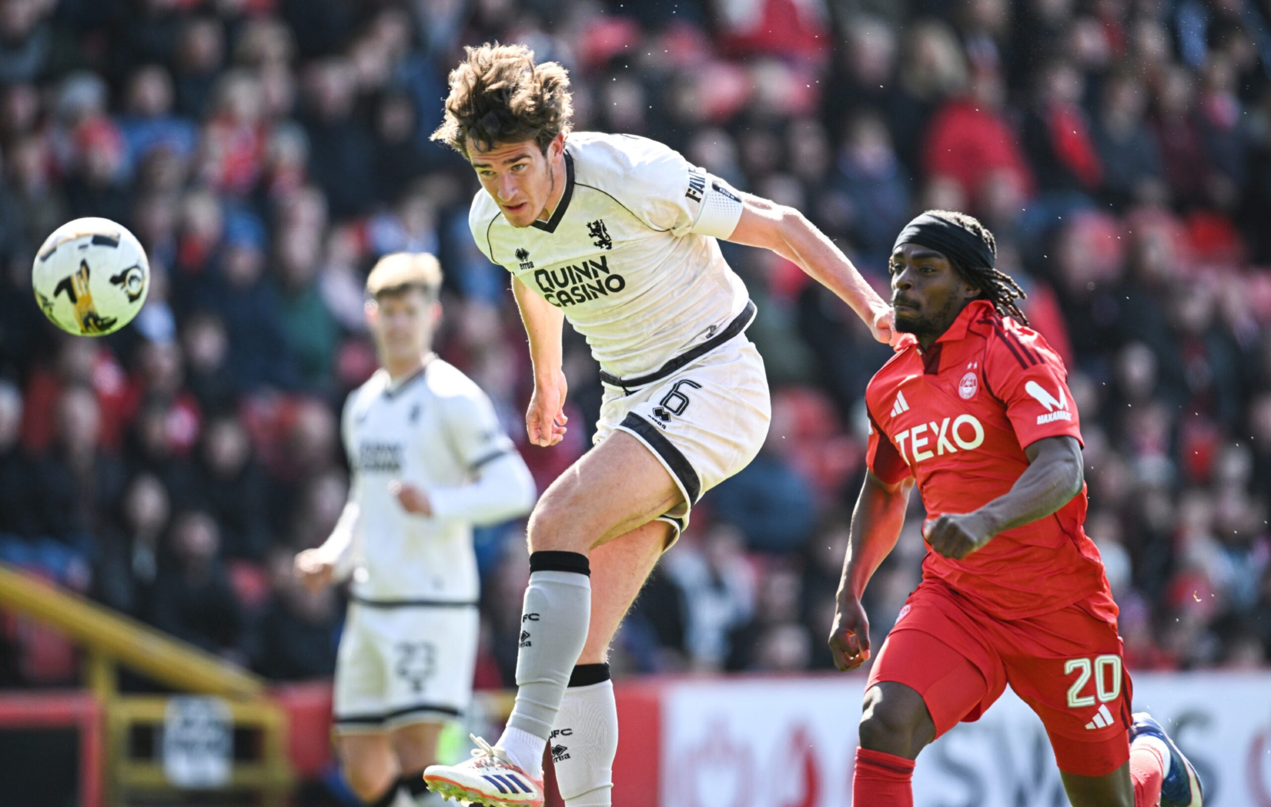 Dundee United's Ross Graham and Aberdeen's Toyosi Olusanya in action during a Premiership match at Pittodrie. 