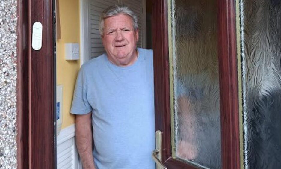 Kevin Frain standing at his front door.