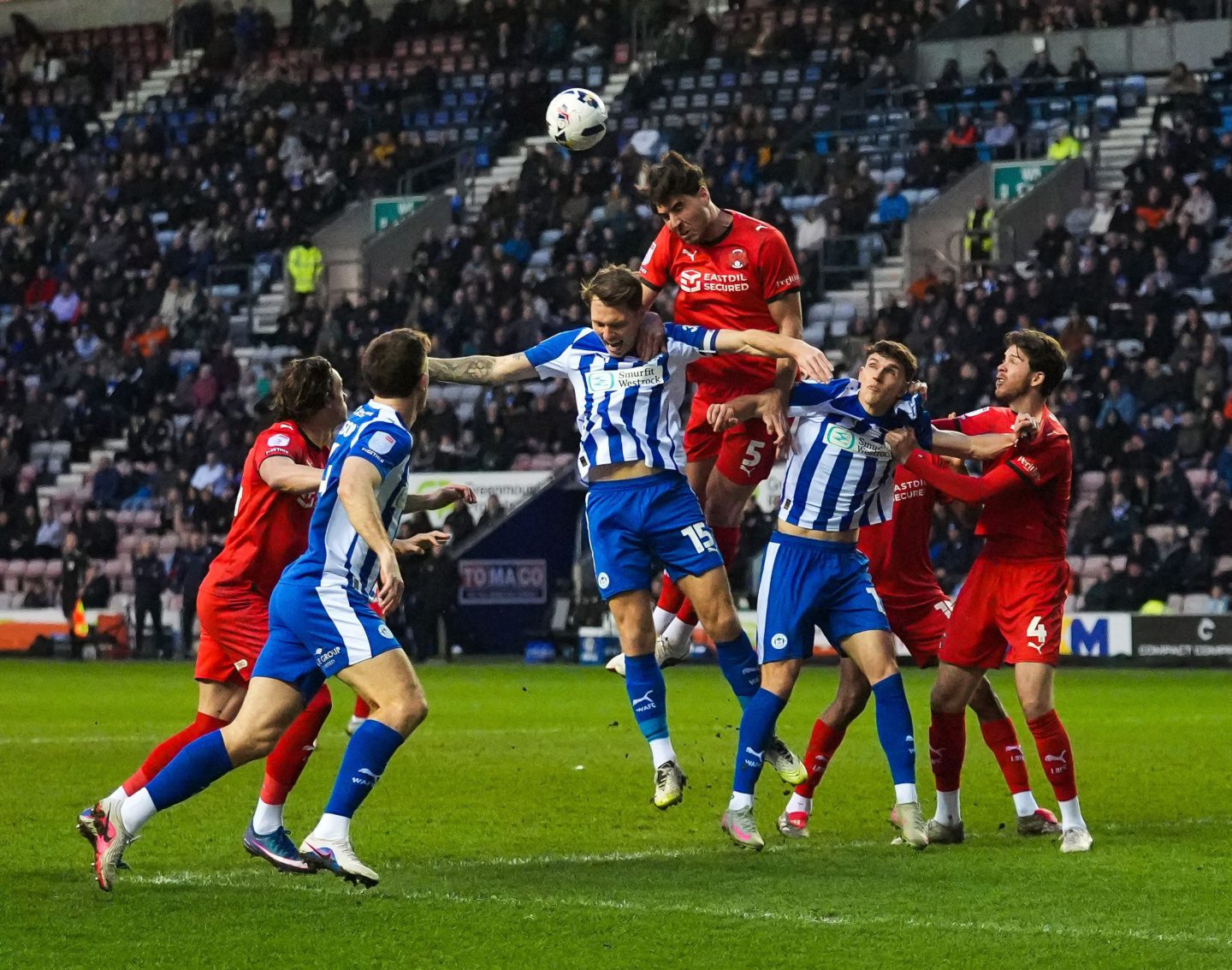 Dan Happe of Leyton Orient (third left) heads the ball clear from a cross during the Sky Bet League 1 match at the Brick Community Stadium, Wigan.