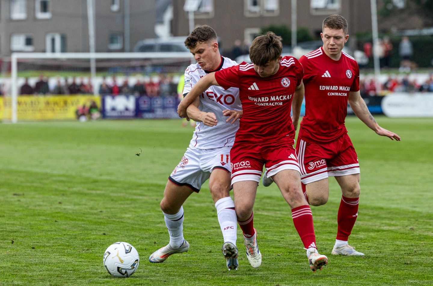Aberdeen's Lewis Smith and Brora's James Wallace in action during a Premier Sports Cup group stage match at Dudgeon Park.