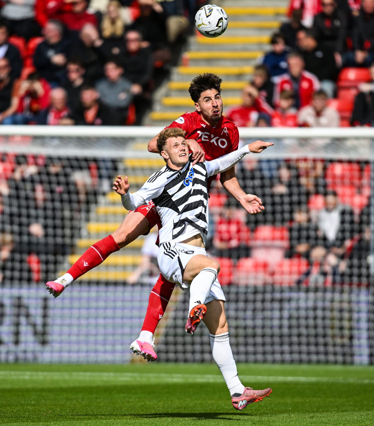 Aberdeen's Dan Happe (L) and Queen's Park's Jack Hamilton (R) in action during a Premier Sports Cup match at Pittodrie.