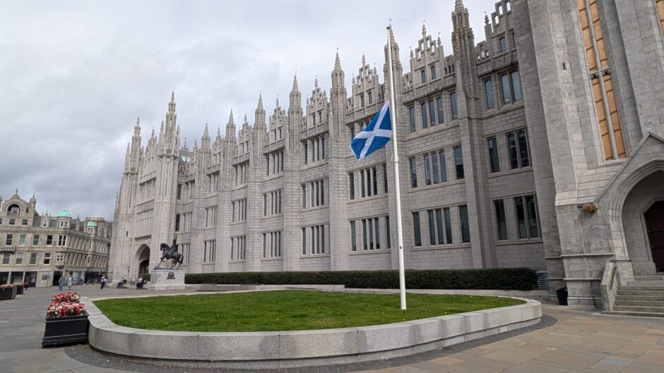 The Saltire at half mast outside Marischal College. Image: Alastair Gossip/DC Thomson