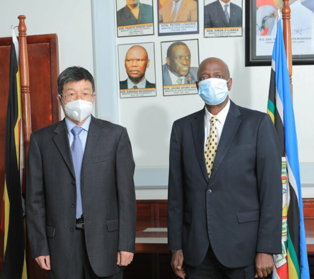 Two men in suits with masks on