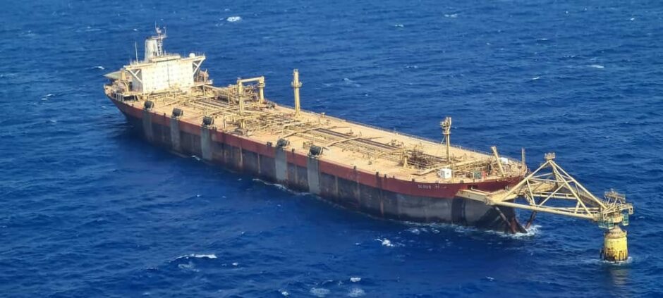 Aerial view of a ship, attached to a mooring point in the sea