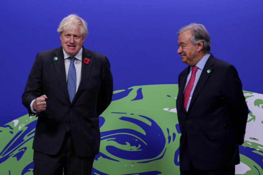 Boris Johnson, U.K. prime minister, left, and Antonio Guterres, secretary general of the United Nations, wait to greet attendees at the COP26 climate talks in Glasgow, U.K., on Monday, Nov. 1, 2021. The United Nations has convened world leaders many times before to discuss climate change, U.S. climate envoy, John Kerry, says COP26 will be the last chance for the world to avoid climate disaster. Photographer: Emily Macinnes/Bloomberg
