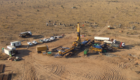 Aerial shot of drill site in dusty surroundings