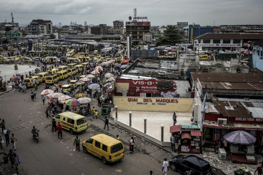 Traffic in buildings, with yellow mini bus