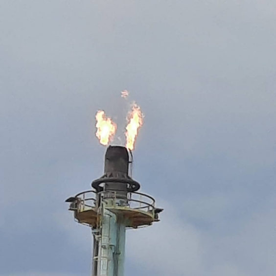 Gas flares from the top of a stack