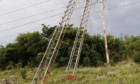A pylon coming out of the earth, leaning against a second set of wires