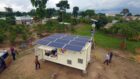 Shipping container with solar panels on the roof in a village