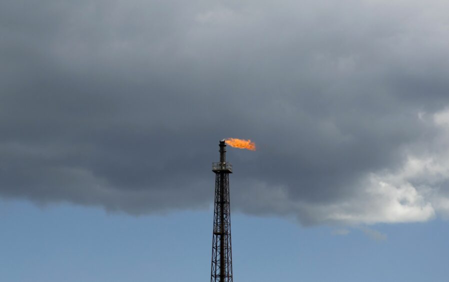 A flare burns off excess gas from a stack at the Cosmo Oil Co. refinery at the Yokkaichi industrial complex in Yokkaichi, Mie Prefecture, Japan, on Saturday, Oct. 29, 2016. Photographer: Tomohiro Ohsumi/Bloomberg