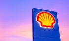 Shell gas station logo with blue sky background during sunset in Thailand.