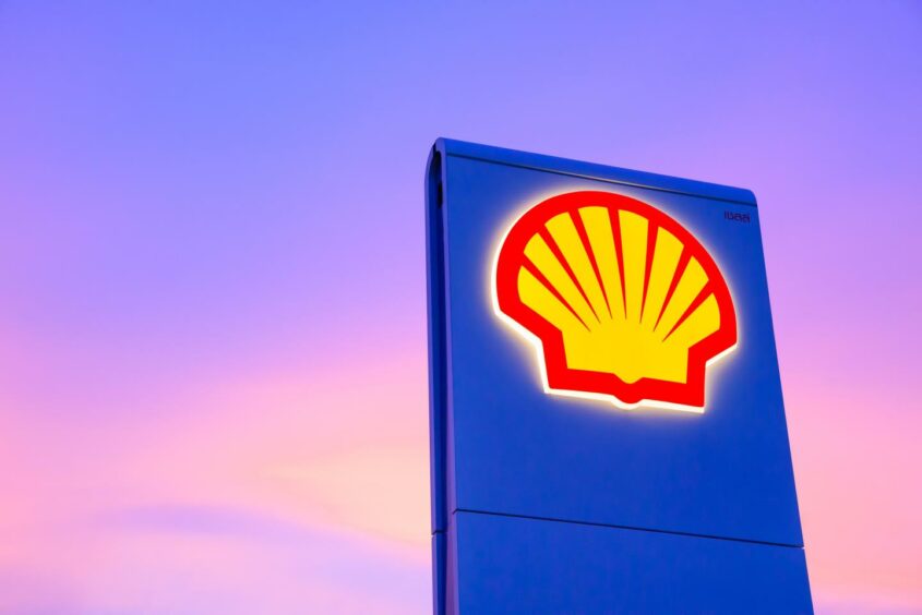 Shell gas station logo with blue sky background during sunset in Thailand.