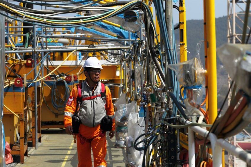 A worker walks along on an FPSO