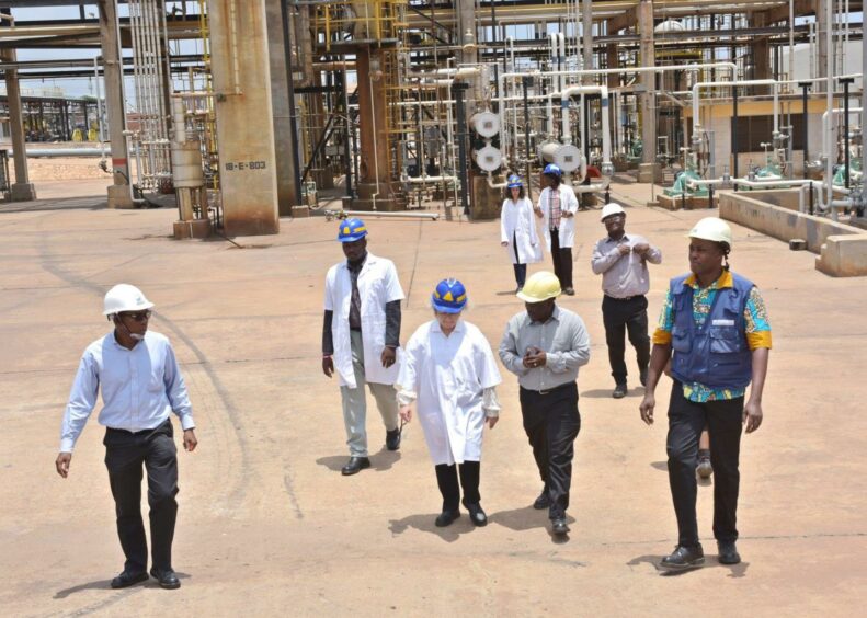 People walk through an industrial site