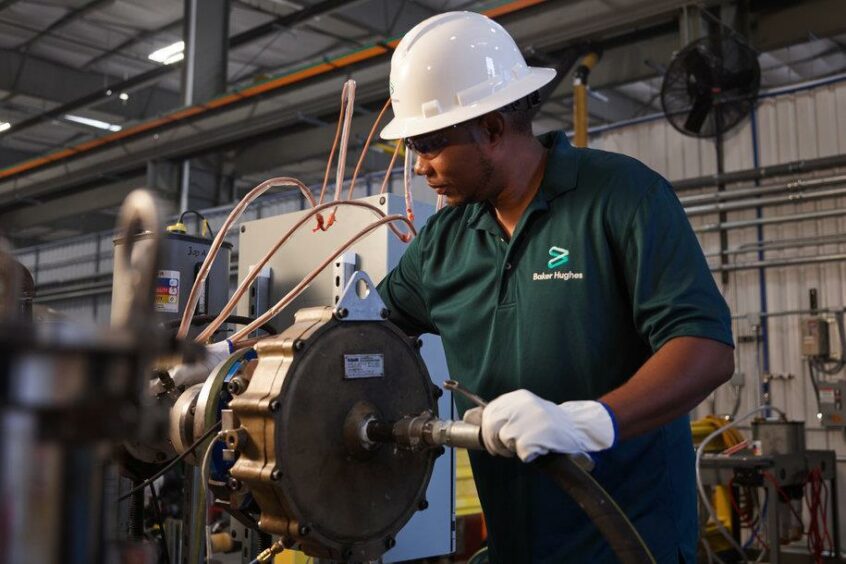 Baker Hughes Oilfield Services Artificial Lift Technician testing an electrical submersible pumping system.